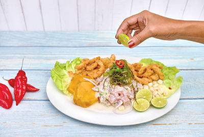 Peruvian food fish ceviche and chicharron de pescado with fried cassava sweet corn and sweet potato 