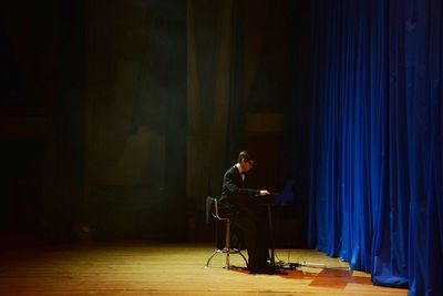 Man sitting on seat in stage