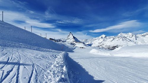 Scenic view of snowcapped mountains against sky