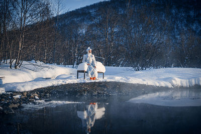 Rear view of man standing on snow covered landscape