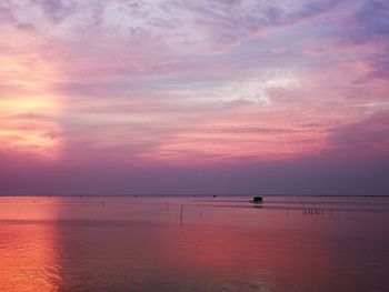 Scenic view of sea against romantic sky at sunset