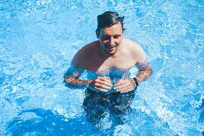 High angle view of man swimming in pool