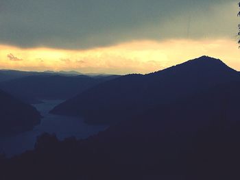 Scenic shot of silhouette mountains against sky at sunset