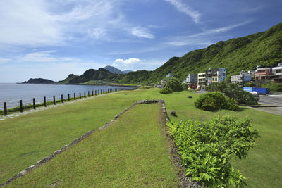 Scenic view of sea and buildings against sky