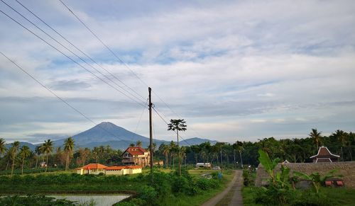 Scenic view of village by building against sky