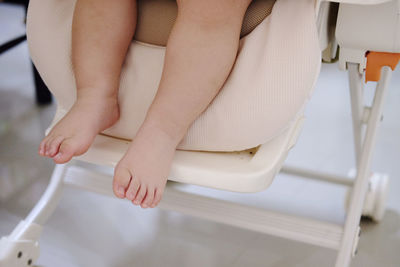 Low section of baby sitting on seat