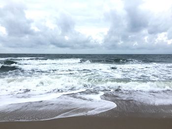 Scenic view of sea against cloudy sky