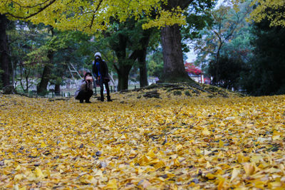 Full length of man amidst plants during autumn