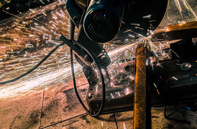 Low angle view of illuminated machinery at night