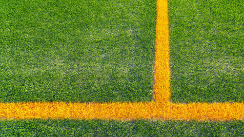 High angle view of yellow lines on soccer field