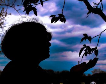 Close-up of silhouette man against sky