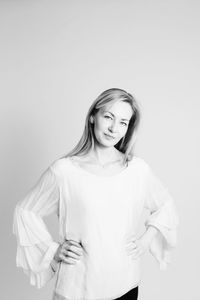 Portrait of a smiling young woman against white background