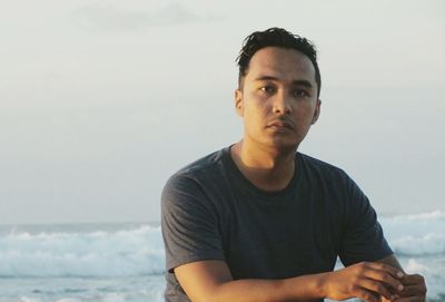 Portrait of man on beach against sky