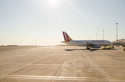 Airplane on runway against clear sky