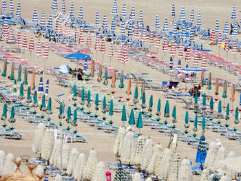 High angle view of closed umbrellas on beach