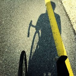 Shadow of man on bicycle