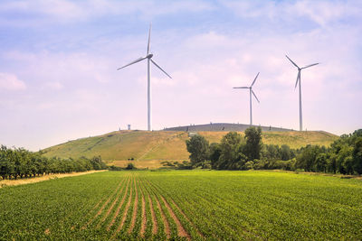 Windmill on field against sky