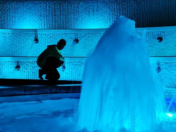 Man standing by swimming pool