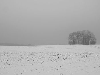 Scenic view of snow covered field against clear sky