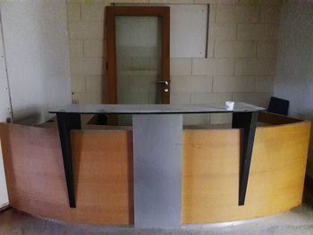 Empty chairs and table against wall at home