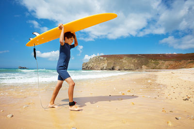 Full length of woman standing at beach