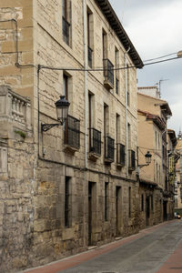 Street amidst buildings in city against sky