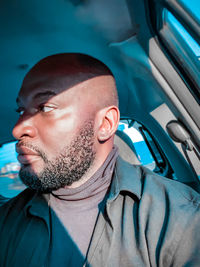 Portrait of young man in car