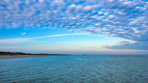 Scenic view of sea against blue sky