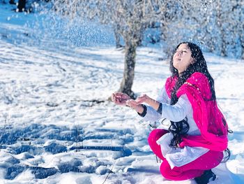 Young woman enjoying snowfall