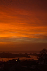 Scenic view of silhouette landscape against romantic sky at sunset