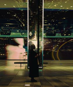 Woman standing in illuminated city at night