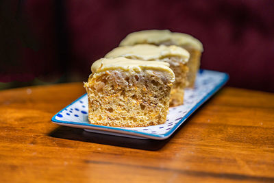 Slices of carrot cake in a plate on a wooden a table