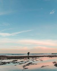 Scenic view of beach against sky during sunset