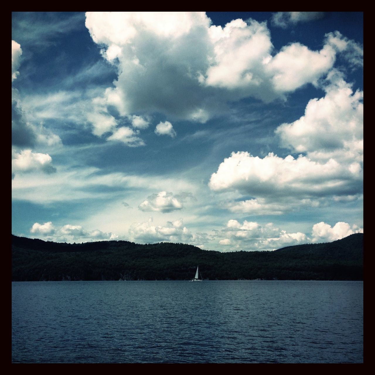 transfer print, water, sky, mountain, tranquil scene, tranquility, waterfront, scenics, auto post production filter, lake, beauty in nature, cloud - sky, mountain range, nature, cloud, cloudy, river, rippled, idyllic, non-urban scene