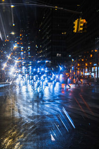 People on illuminated street at night