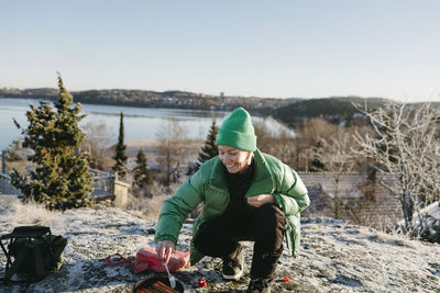 Woman preparing food outdoors at winter