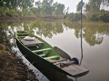 Boats moored in lake against sky