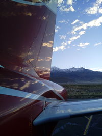 Close-up of airplane window against sky