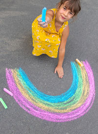 High angle view of boy playing with toy on road