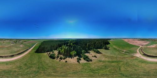 Scenic view of landscape against blue sky