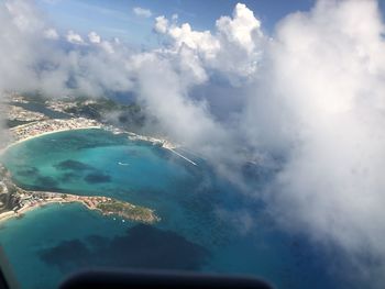 Aerial view of sea and mountains against sky