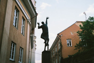 Low angle view of statue against building