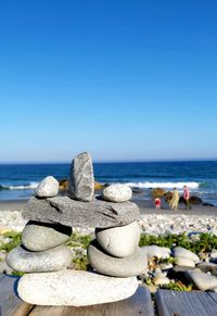 Rocks piled and family on beach