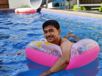 Portrait of smiling boy in swimming pool