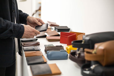 Midsection of man holding suitcase