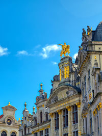 Low angle view of buildings against blue sky