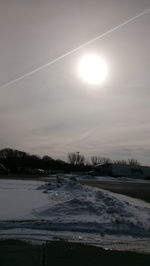 Scenic view of snow covered landscape against sky during sunset