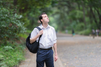 Full length of teenage girl looking away on field