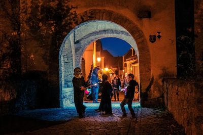 People standing in illuminated building at night