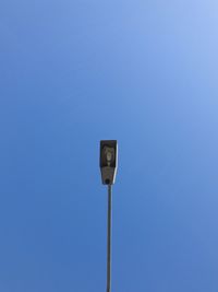 Low angle view of street light against clear blue sky
